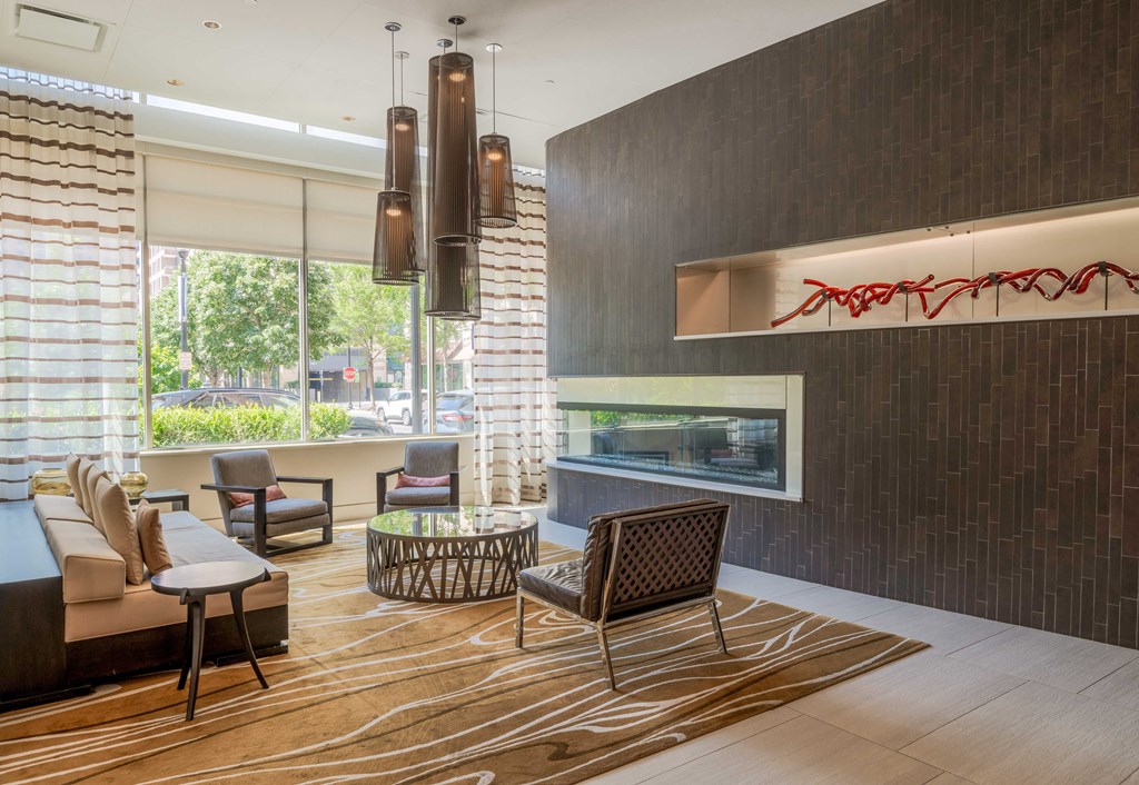 a living room with a couch and chairs and a fireplace